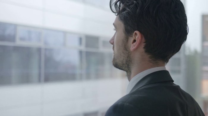 82289_videoblocks-close-up-of-handsome-businessman-looking-through-the-window-young-man-wearing-a-suit-taking-a-break-at-his-office-and-thinking_b1wgnj2ce_thumbnail-full05.png